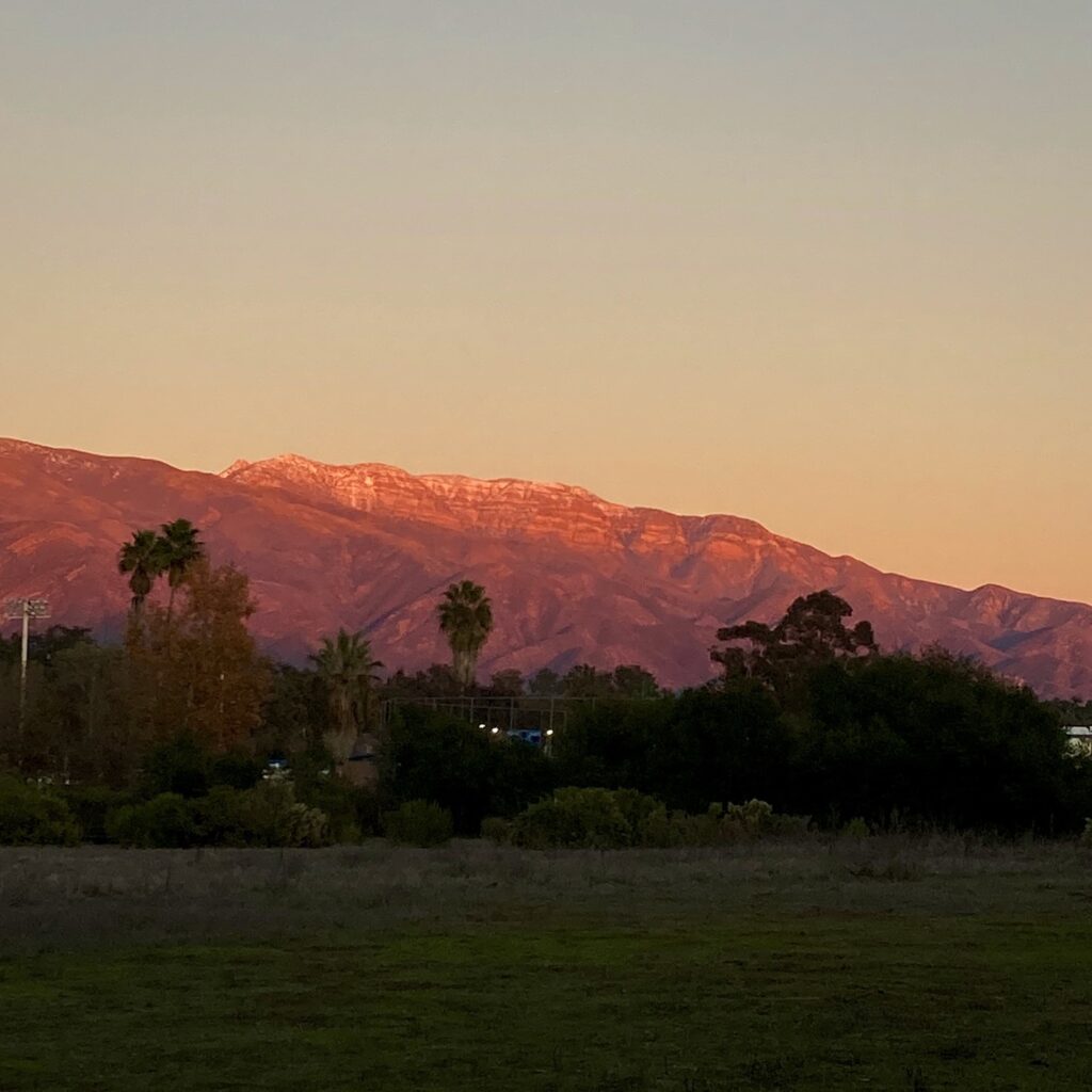 A mountain range in the Ojai Valley turning pink at sunset.