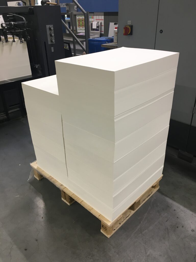 A towering pallet of pristine white paper.