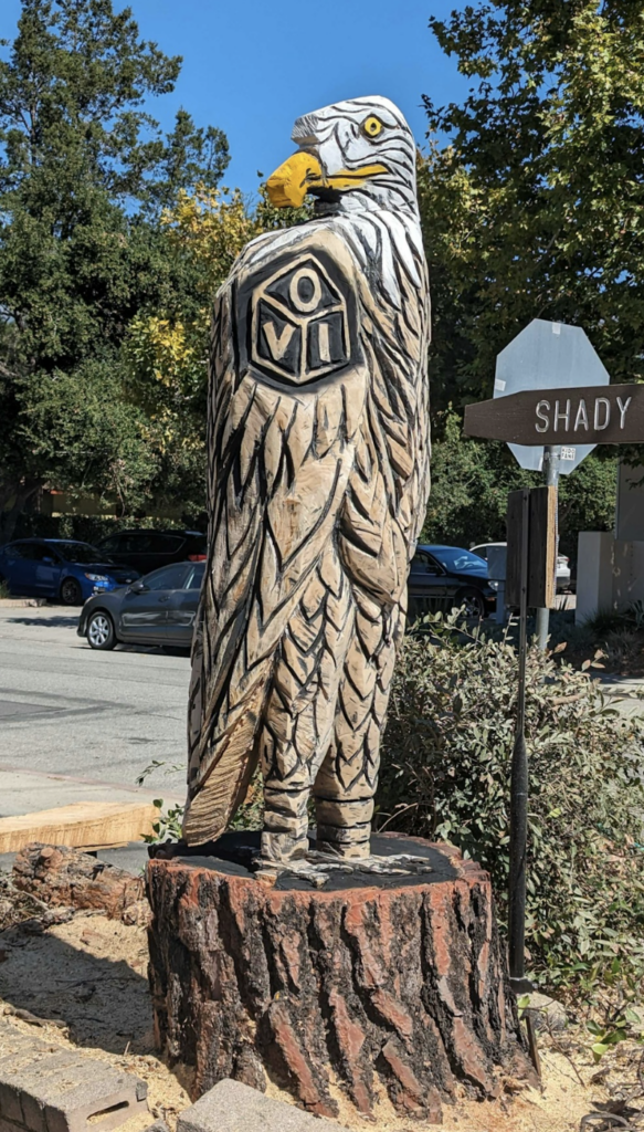 A carved wooden statue of a bald eagle.