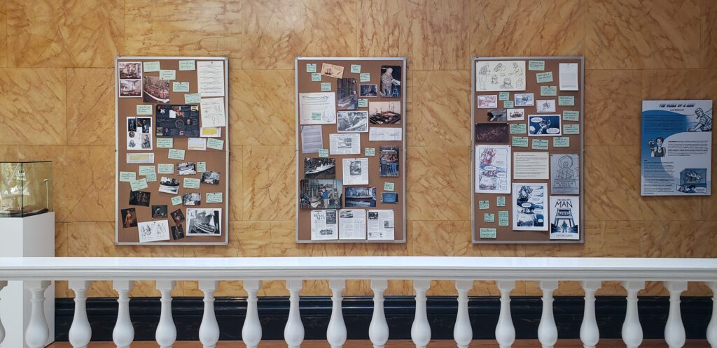 Three bulletin boards showing Lucy's notes and process for developing the project on a gallery wall.
