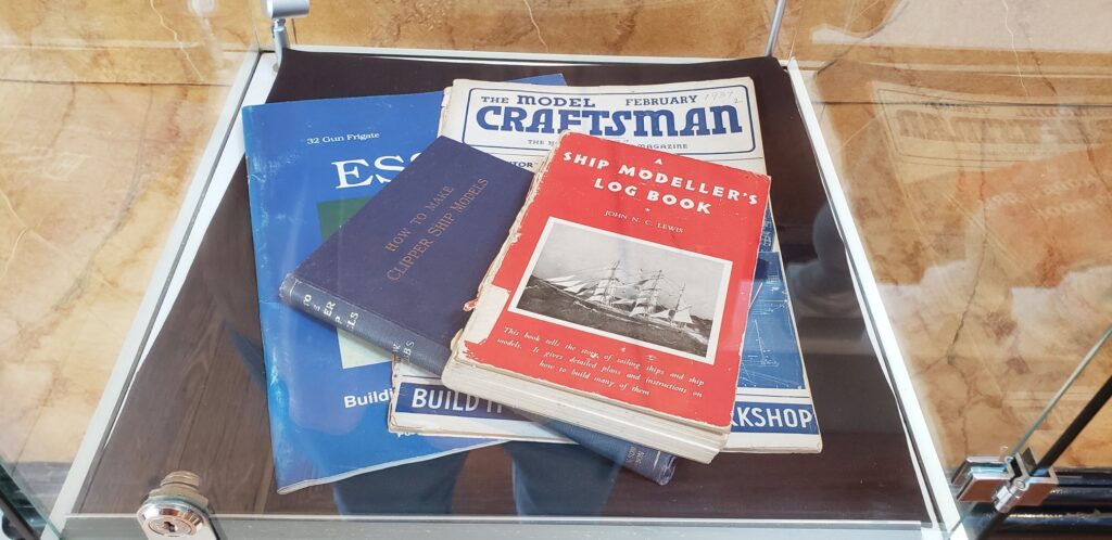 A display case showing a selection of model-making books from Hitchcock's collection.
